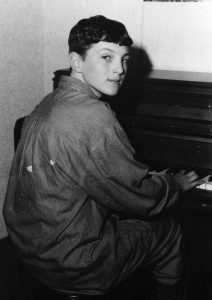 This mid 1990s photograph shows Jimmy Henderer '96 practicing the piano.