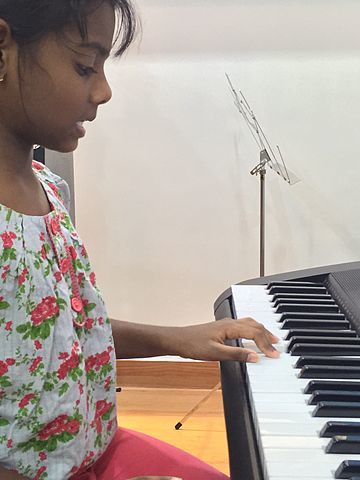 girl playing piano