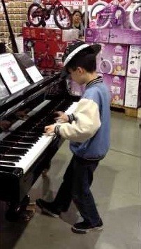 boy plays piano
