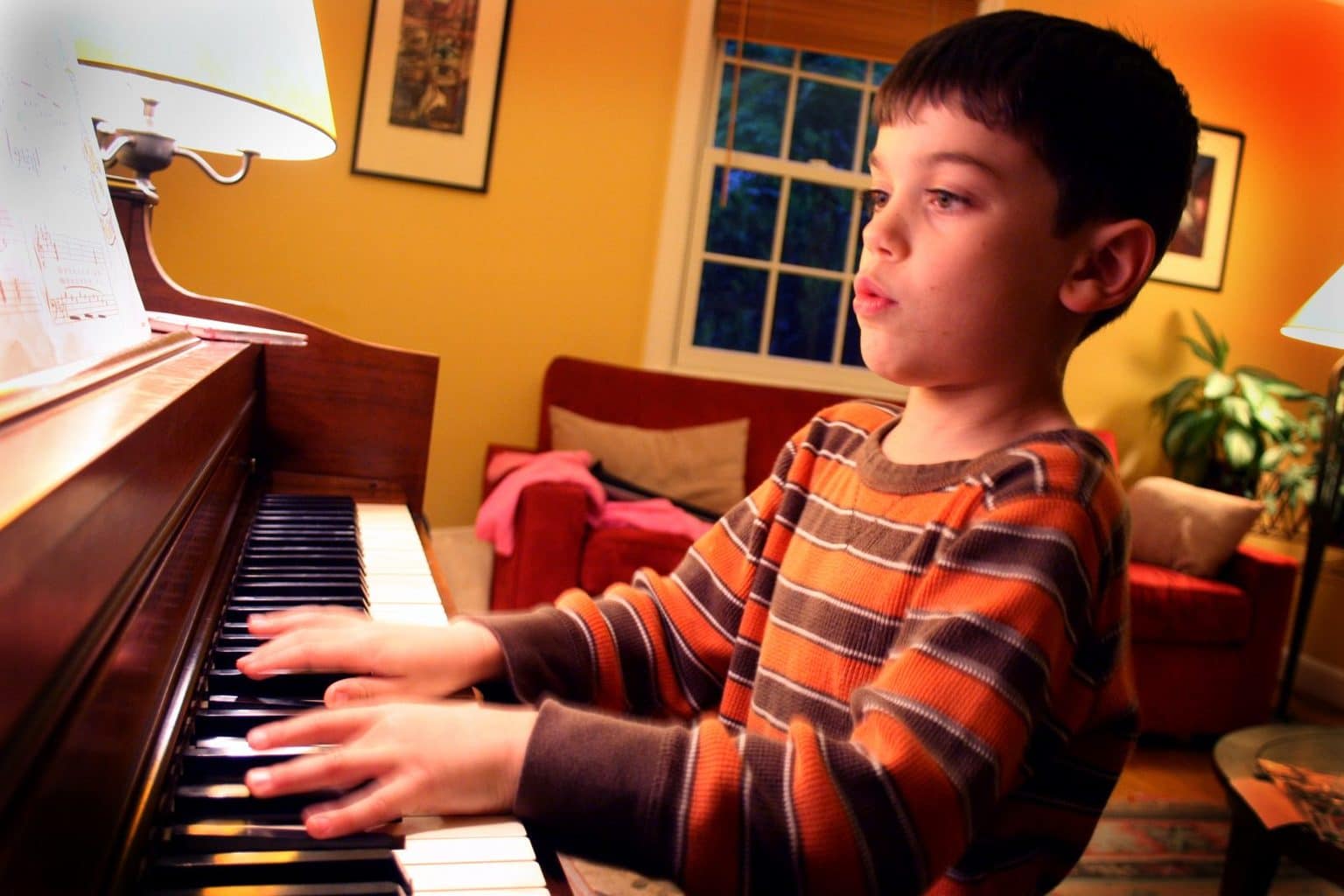 boy practising piano
