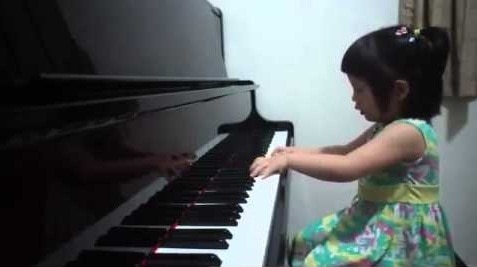 small girl playing piano