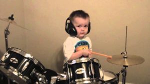 motivated boy playing drums alone