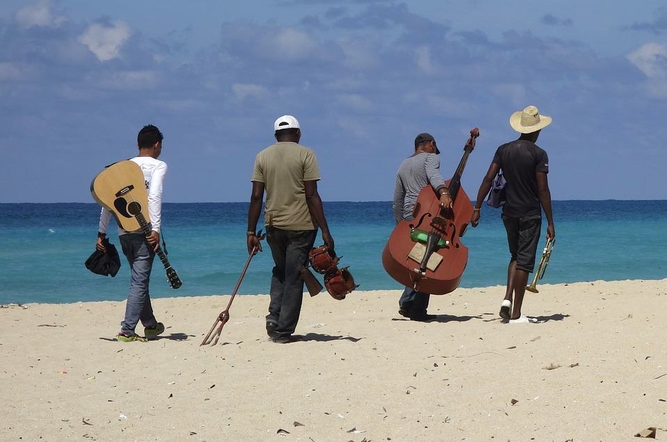 music band members walking to the beach