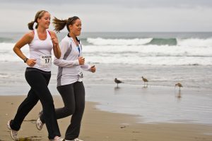 two ladies jogging at the beach