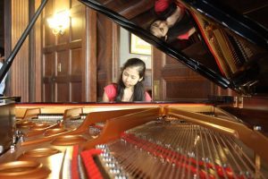 girl playing the piano