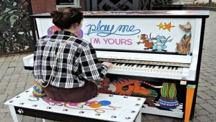 lady playing the piano outdoors