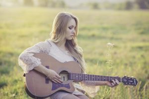 sad lady playing the guitar