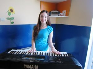 girl playing the keyboard