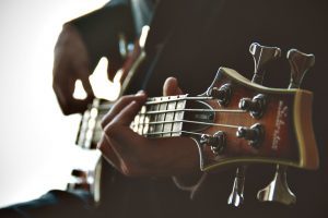 side view of a man playing guitar