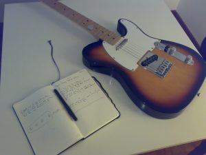 song composition book and guitar