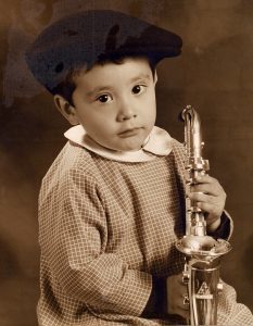 child holding a saxophone