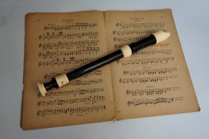 a flute and an old music sheet