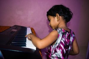 little girl playing the piano