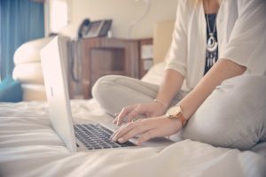 woman typing something on her laptop