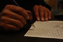 man going through a piece of written paper