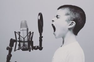 boy screaming into the microphone