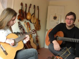 woman learning to play the guitar