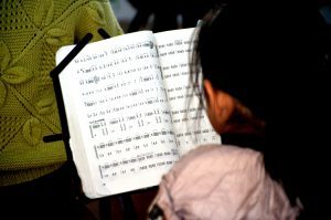 a child reading sheet music