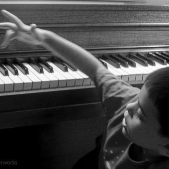 little boy playing the piano