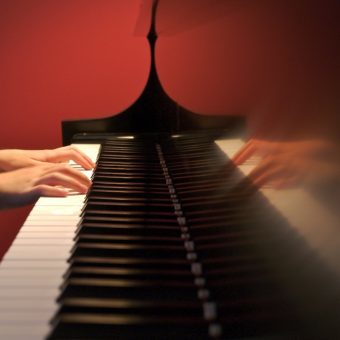 reflection of hands playing piano