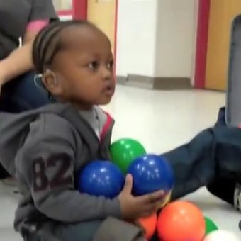 little girl playing with colored balls