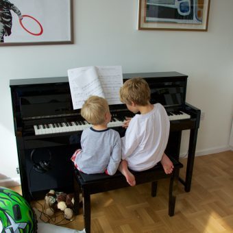 boys playing piano