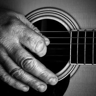 man strumming the guitar