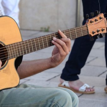 man holding a guitar chord