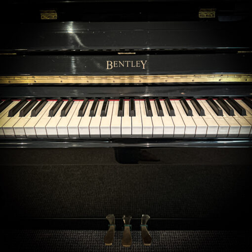 Detail of Bentley Logo on used upright piano