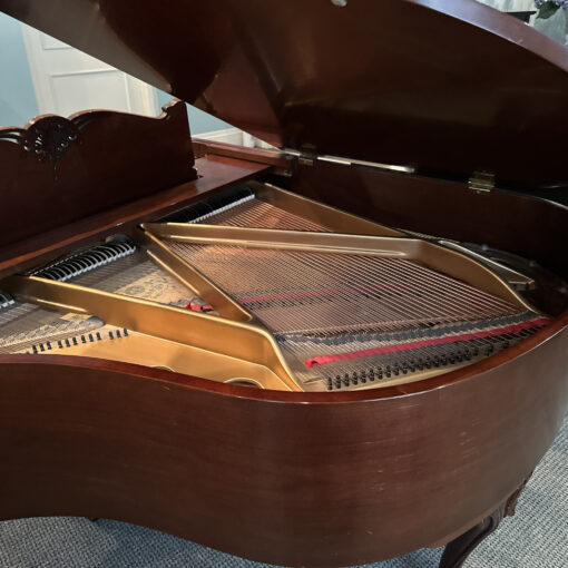 Detail image of the interior of a vintage Chickering and Sons Louis XV style baby grand piano in satin mahogany