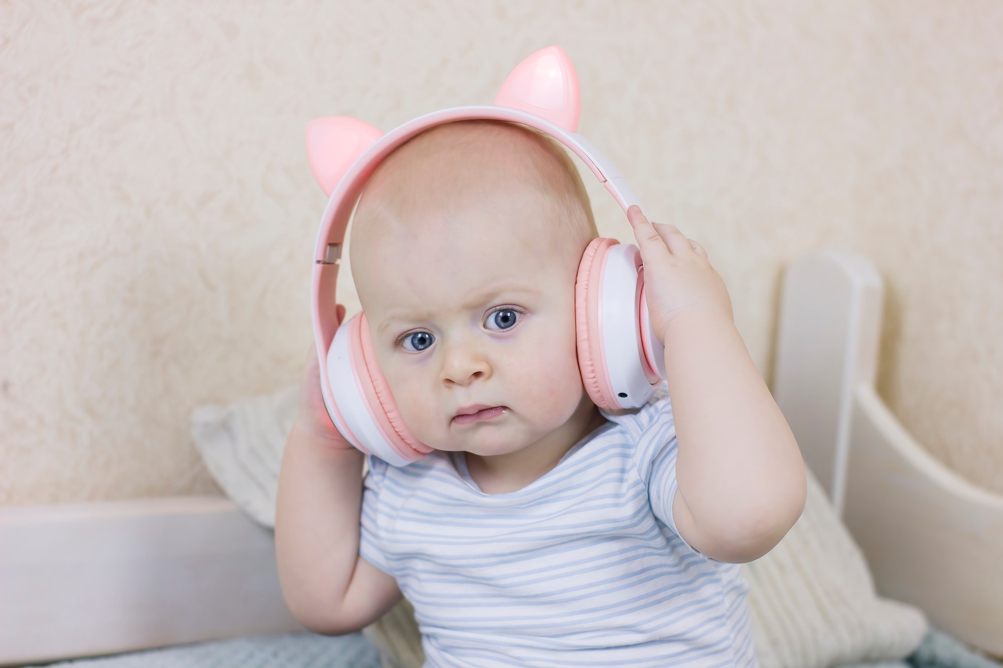 Cute Baby boy with headphones listening to music.