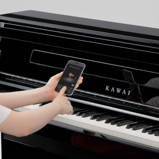 Image showing someone using a smartphone with Kawai CA901 in Ebony Polish