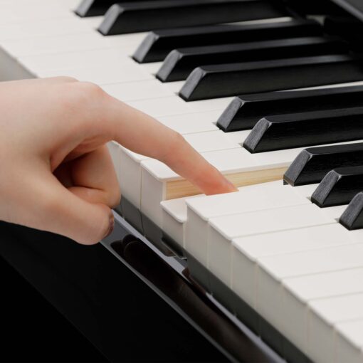 Image showing someone pressing a piano key on a Kawai CA901