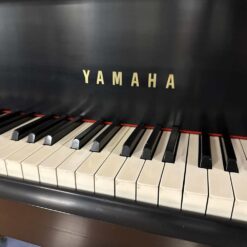 Used Yamaha C7 Grand Piano in Satin Ebony Logo