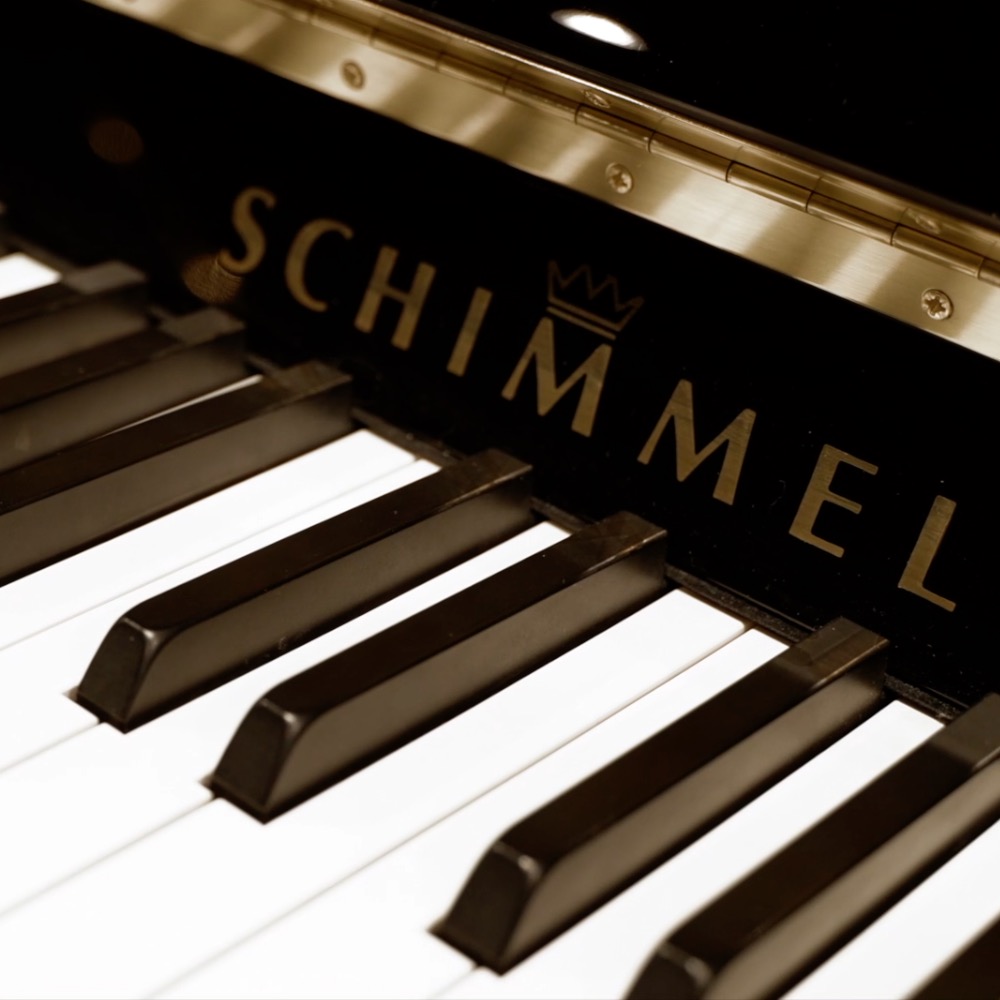 Image of front of upright piano in black polish