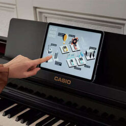 Casio AP-550 digital piano with the Casio Music Space app shown on the music desk