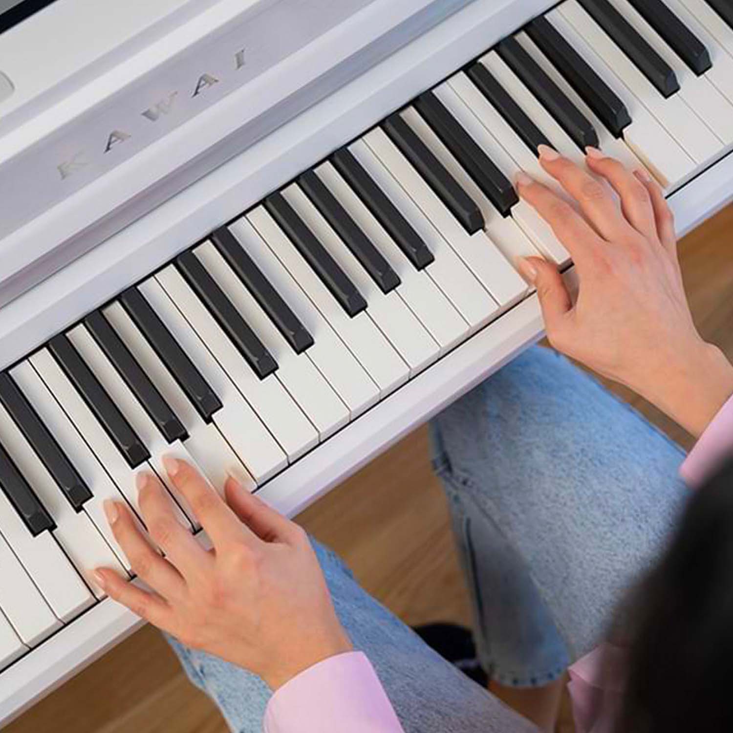Closeup image of woman's hands playing a Kawai CA501 keyboard