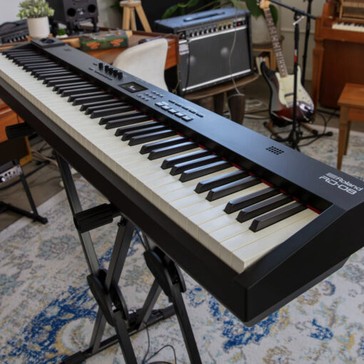 Side angle image of the Roland RD-08 Stage Piano in a musical living room.