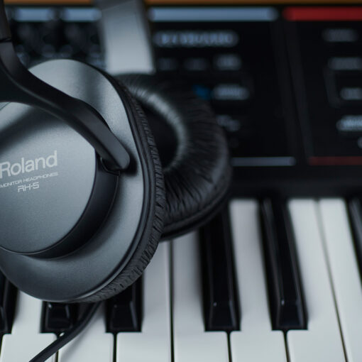 Detail image of a pair of Roland RH-5 Headphones sitting on top of a Juno DS-88 Roland Keyboard