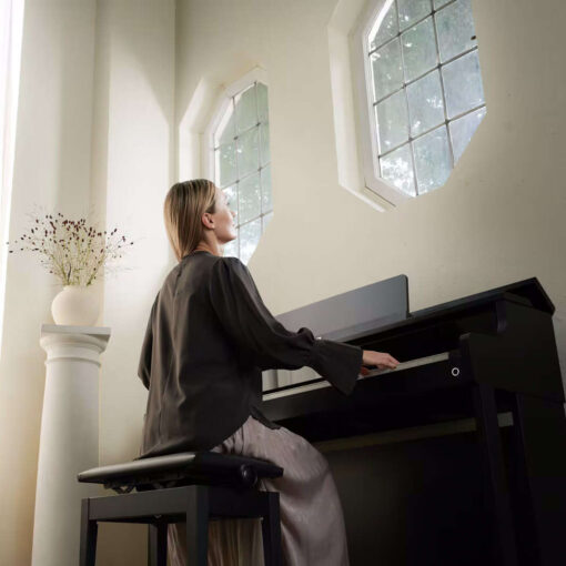 A woman playing a Casio AP-750BK digital piano